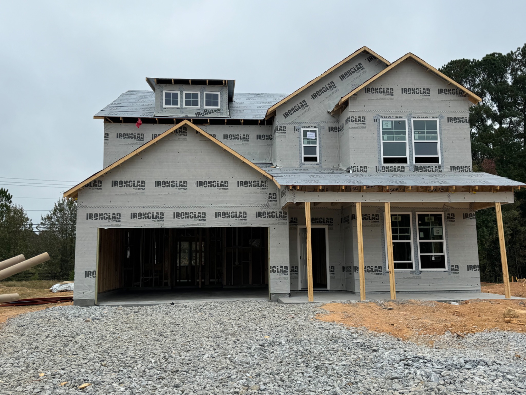 Front of a house with installed windows and entry openings