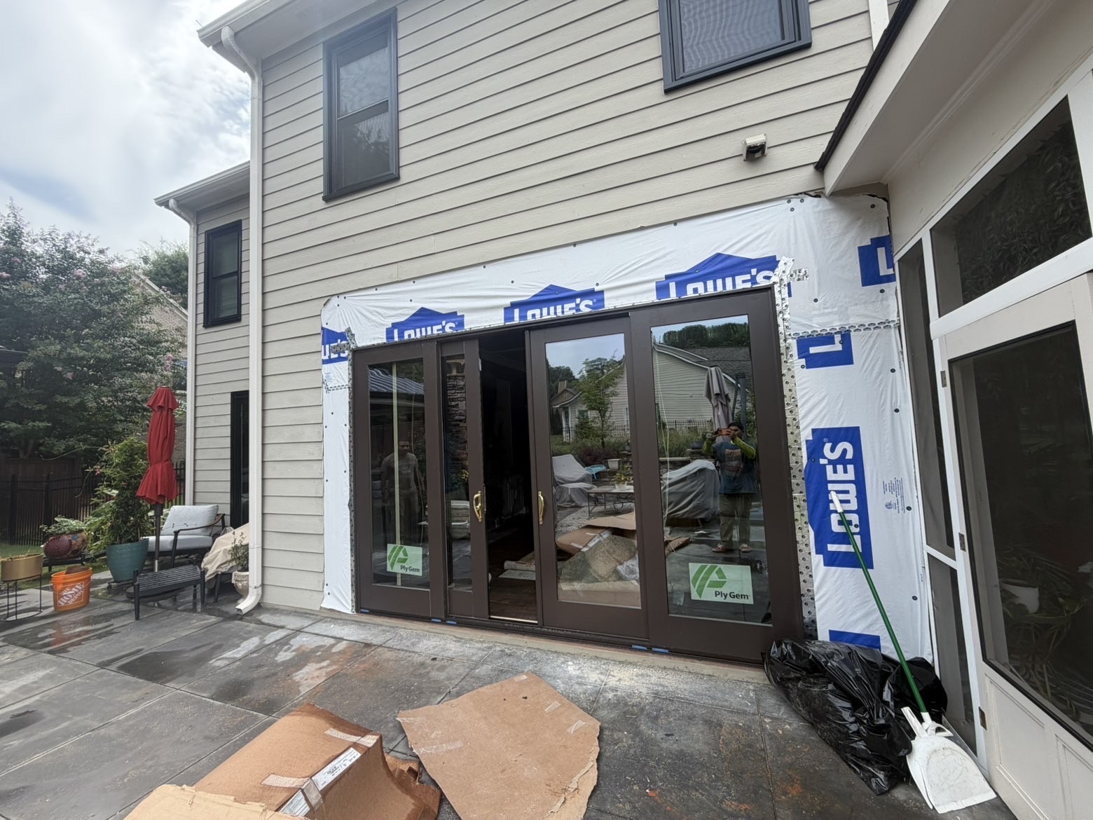 New glass patio doors installed in a home exterior during renovation